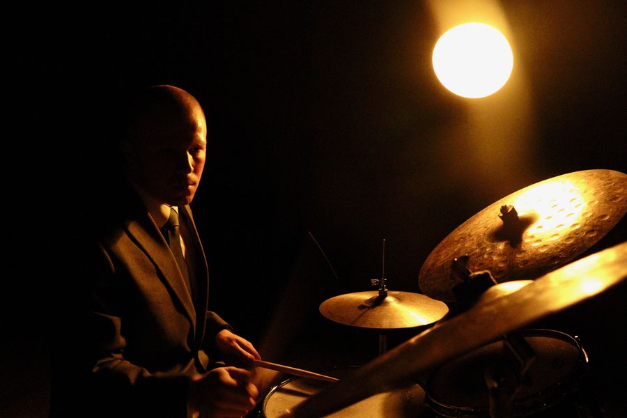 Joey Porth in profile, behind a cymbal